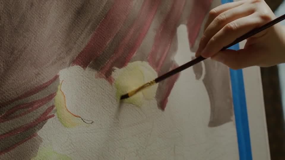 Illustrative stock film of a painter brushing a canvas