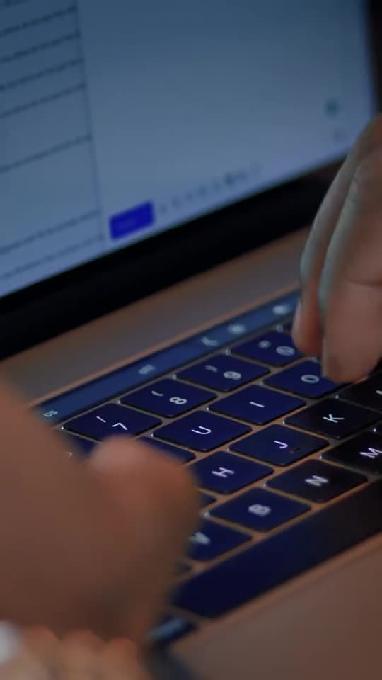 Illustrative stock photograph of hands working on a laptop